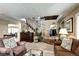 Spacious living room with view of entryway and staircase, showcasing comfortable seating and ample natural light at 4907 Fenwood Dr, Highlands Ranch, CO 80130