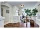 Open loft area with hardwood floors, iron railing, and views of the entryway below at 4907 Fenwood Dr, Highlands Ranch, CO 80130