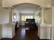 A home office space with columns framing a desk area and featuring hardwood flooring at 4907 Fenwood Dr, Highlands Ranch, CO 80130