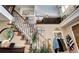 Grand foyer with a staircase adorned with Gathering photos and natural light at 4907 Fenwood Dr, Highlands Ranch, CO 80130