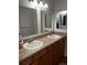 Bathroom featuring double sinks with a countertop and large mirror at 6392 S Hill St, Littleton, CO 80120