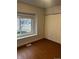 Bedroom featuring laminate flooring, window, and closet at 6392 S Hill St, Littleton, CO 80120