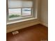 Bedroom featuring laminate flooring and street view window at 6392 S Hill St, Littleton, CO 80120