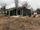 Exterior of home featuring dark siding and a concrete patio near the front at 6392 S Hill St, Littleton, CO 80120