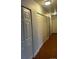 Hallway featuring closet doors and wood flooring with lights on the ceiling at 6392 S Hill St, Littleton, CO 80120