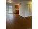 Open-concept space featuring laminate flooring and sliding glass door at 6392 S Hill St, Littleton, CO 80120