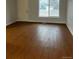 Bright living room featuring laminate flooring and a large window at 6392 S Hill St, Littleton, CO 80120
