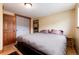 Bedroom featuring queen bed, wood floors, closet, doors to hallway and closet, and lots of light at 32 Magnum Bonum Dr, Breckenridge, CO 80424