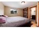 Bedroom featuring a cozy queen bed, a window with neighborhood views, and an ensuite bathroom at 32 Magnum Bonum Dr, Breckenridge, CO 80424