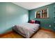 Cozy bedroom with wood floors, natural light and a view of trees through the window at 32 Magnum Bonum Dr, Breckenridge, CO 80424