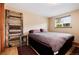 Bedroom with a large bed, wood floors, a window, and decorative wood at 32 Magnum Bonum Dr, Breckenridge, CO 80424