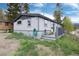 Exterior view of the home featuring a small deck and well-maintained yard at 32 Magnum Bonum Dr, Breckenridge, CO 80424