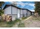 Charming home with horizontal siding, a white front door, stacked firewood, and a gravel yard at 32 Magnum Bonum Dr, Breckenridge, CO 80424