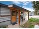 Home featuring a cozy front entrance with a wood door and covered porch at 32 Magnum Bonum Dr, Breckenridge, CO 80424
