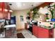 Bright kitchen with red cabinets, stone countertops, stainless appliances, and views to the exterior at 32 Magnum Bonum Dr, Breckenridge, CO 80424