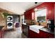 Updated kitchen featuring red cabinets, stainless appliances, farmhouse sink, and eat-in dining at 32 Magnum Bonum Dr, Breckenridge, CO 80424
