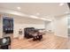 Finished basement area features wood-look floors, recessed lighting, and open layout with additional room at 10661 W 104Th Ave, Broomfield, CO 80021