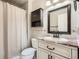 Bathroom featuring neutral tile, marble countertops, a shower, and a sink with a large mirror at 10661 W 104Th Ave, Broomfield, CO 80021