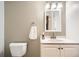 Bathroom featuring vanity with a large mirror, neutral tones and a toilet with towel at 10661 W 104Th Ave, Broomfield, CO 80021