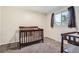 Bedroom with a crib and changing table featuring a large window for natural light at 10661 W 104Th Ave, Broomfield, CO 80021