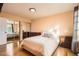 Bedroom with hardwood floors, a large closet with mirrored doors, and ample sunlight at 10661 W 104Th Ave, Broomfield, CO 80021