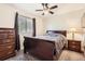Cozy bedroom featuring neutral colored carpet, a queen sized bed, and a large window at 10661 W 104Th Ave, Broomfield, CO 80021