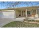 Inviting covered front porch featuring brick accents, lovely landscaping and two car garage at 10661 W 104Th Ave, Broomfield, CO 80021