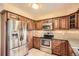 Functional kitchen with stainless steel appliances, ample cabinet space, and neutral paint at 10661 W 104Th Ave, Broomfield, CO 80021