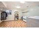 Bright laundry room with washer, dryer, shelving, and wood-look floors at 10661 W 104Th Ave, Broomfield, CO 80021