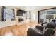 This living room features a large window, a fireplace, hardwood floors, and sliding glass doors to the deck at 10661 W 104Th Ave, Broomfield, CO 80021