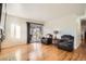 Bright living room with hardwood floors, neutral walls, and sliding glass doors to the deck at 10661 W 104Th Ave, Broomfield, CO 80021