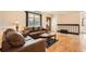 Spacious living room featuring hardwood floors, neutral walls, and comfortable furnishings at 10661 W 104Th Ave, Broomfield, CO 80021