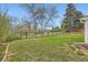 Large backyard enclosed by a black metal fence, with a path visible beyond the perimeter at 6238 S Cherry Cir, Centennial, CO 80121