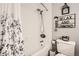 Bathroom with tub and shower, decorative floral curtain, and matching wall decor at 6238 S Cherry Cir, Centennial, CO 80121