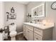 Neutral toned bathroom vanity with quartz countertop and lighted mirror at 6238 S Cherry Cir, Centennial, CO 80121