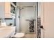 Bathroom with glass enclosed shower, storage cabinet, toilet, and towel rack at 6238 S Cherry Cir, Centennial, CO 80121