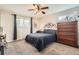 Comfortable bedroom with plush carpeting, ample natural light, and classic ceiling fan at 6238 S Cherry Cir, Centennial, CO 80121