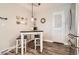 Cozy dining area with a small table, stools, and a decorative gallery wall, perfect for casual meals at 6238 S Cherry Cir, Centennial, CO 80121