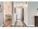 Welcoming entryway with hardwood floors, decorative rug and stylish lighting, leading to adjacent dining area at 6238 S Cherry Cir, Centennial, CO 80121