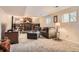 Cozy finished basement living room with brick fireplace and built-in bookshelves at 6238 S Cherry Cir, Centennial, CO 80121
