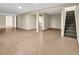 Finished basement with a doorway leading to another space and a staircase for convenient access at 4559 Ashfield Dr, Boulder, CO 80301