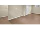 Unfinished basement area with brown floor, neutral walls and a white door and a window at 4559 Ashfield Dr, Boulder, CO 80301