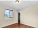 Cozy bedroom with neutral walls, laminate flooring, and a large window at 4559 Ashfield Dr, Boulder, CO 80301