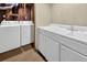 Functional laundry room with white cabinets, sink, and washer-dryer hookups at 4559 Ashfield Dr, Boulder, CO 80301