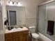 Full bathroom with standard vanity, shower-tub combo with glass doors, and neutral finishes at 16366 E Fremont Ave # 11, Aurora, CO 80016