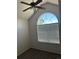 Bedroom showcasing vaulted ceiling, fan, a large arched window with ample natural light at 16366 E Fremont Ave # 11, Aurora, CO 80016