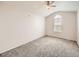 Vaulted bedroom with an arched window, neutral carpeting, and a ceiling fan at 16366 E Fremont Ave # 11, Aurora, CO 80016
