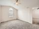 Bright, carpeted bedroom featuring a vaulted ceiling and arched window at 16366 E Fremont Ave # 11, Aurora, CO 80016
