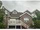 Charming multi-level townhome boasts brick accents and a cozy outdoor deck with stairs at 16366 E Fremont Ave # 11, Aurora, CO 80016
