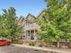 Beautiful townhome with brick and siding exterior, balcony, gated patio, and landscaped entrance at 16366 E Fremont Ave # 11, Aurora, CO 80016